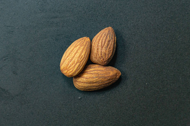 The Almond on black Ceramic Plate close up image. - Photo, Image