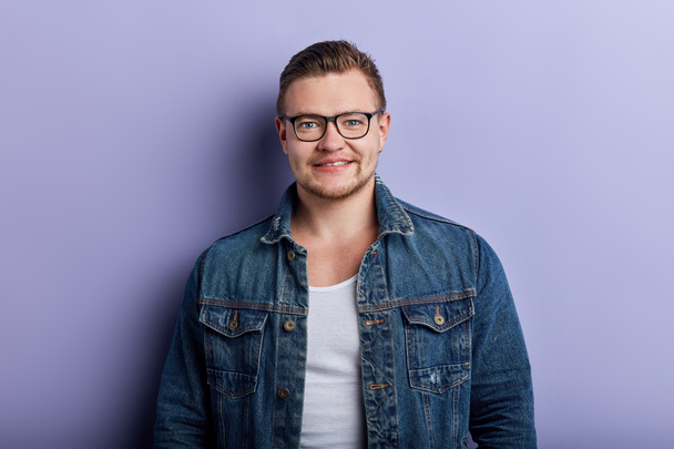 Portrait of handsome stylish young man in glasses posing to the camera - Fotoğraf, Görsel