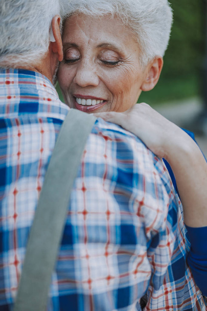 Woman hugging her man and looking happy stock photo - Fotoğraf, Görsel