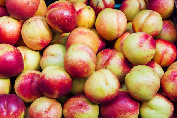 Background of ripe nectarines in the street market. - Photo, Image