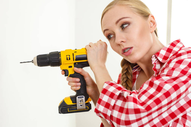 Woman having troubles using drill - Fotó, kép
