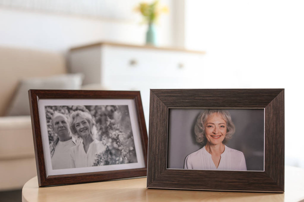 Portraits in stylish frames on table indoors - Φωτογραφία, εικόνα