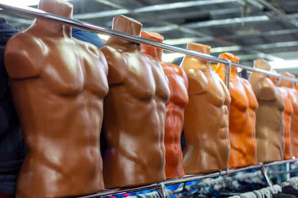 Many different plastic naked male mannequins in the clothing shop. - Photo, Image
