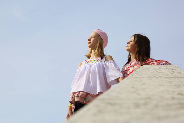 Teen girls are walking as a tourists on Murano island, Veneto, Italy - 写真・画像