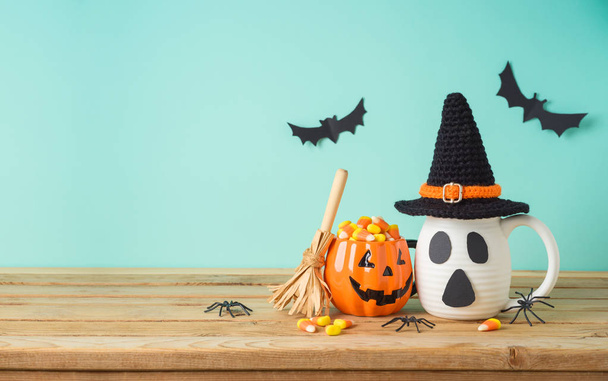 Halloween holiday concept with jack o lantern cup, candy corn, w - Φωτογραφία, εικόνα