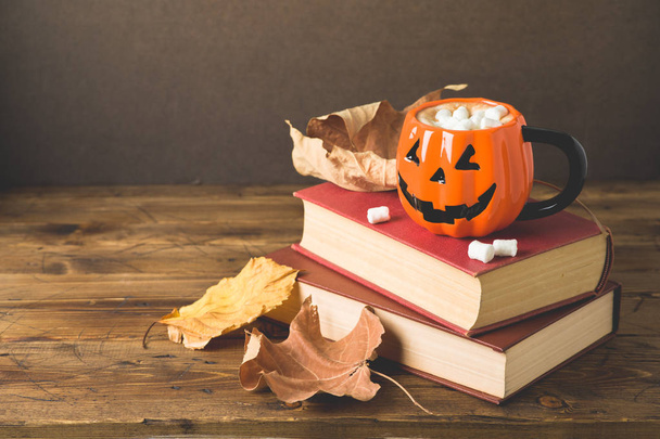 Halloween holiday concept with hot chocolate cup, books and autu - Valokuva, kuva