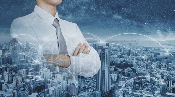 Businessman in white shirt with arm crossed, double exposure futuristic city networking - Photo, Image