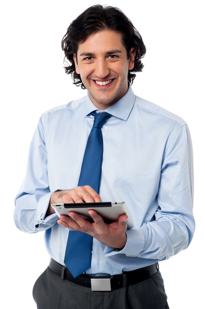 Young businessman operating tablet device - Fotó, kép