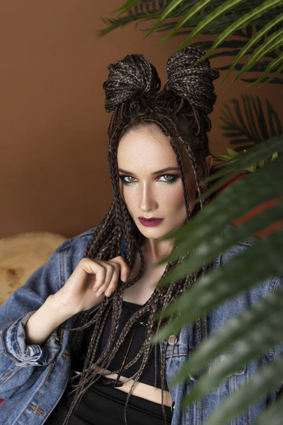 Beautiful girl with an afro cornrows hairstyle, wearing a casual - Фото, зображення