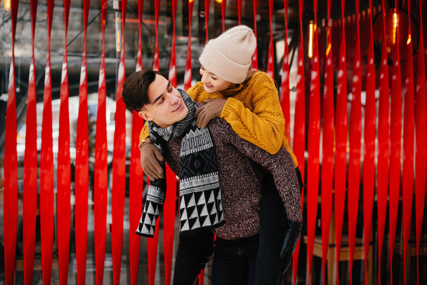 Cute and loving couple in a winter city - 写真・画像