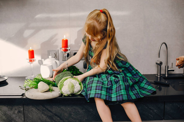 Little girl in a kitchen - Фото, изображение