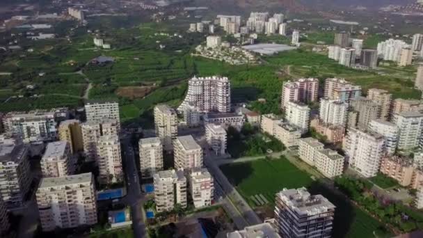 Top view of agricultural fields with green plants in city. Clip. Plots of agricultural fields with greenhouses growing food plants for local population - Footage, Video