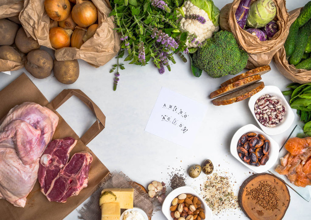 Super food rich in amino acids, for body builders with lean meat, dairy products, spinach, mint, vegetables, beans, salmon fish and vitamin pills on green wood background. - Photo, Image