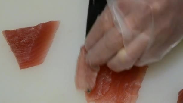Asian chef cutting tuna steak in the kitchen on white table - Séquence, vidéo