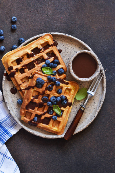 Belgian waffles for breakfast with chocolate sauce  - Фото, изображение