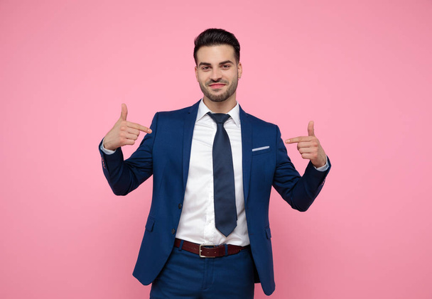 attractive young man pointing fingers to himself on pink backgro - Foto, immagini