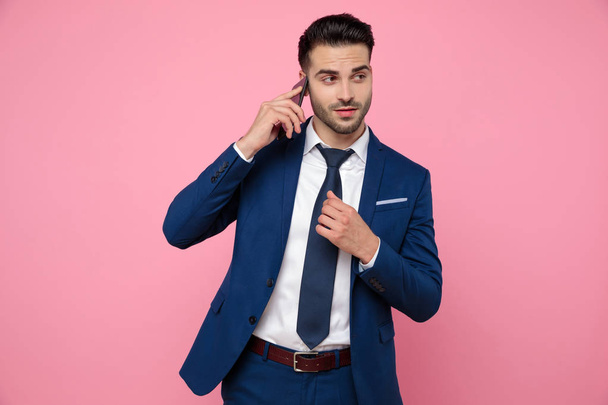smart casual man wearing navy blue suit and talking on the phone - Photo, Image