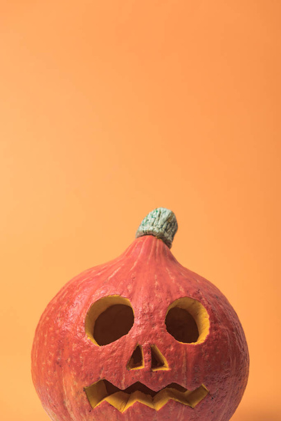 spooky Halloween pumpkin on orange background - Foto, Imagem