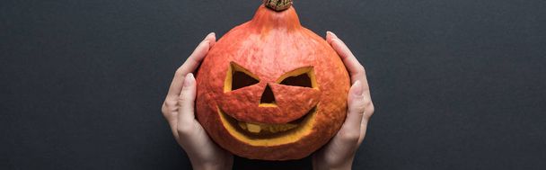 panoramic shot of Halloween pumpkin on black background - Photo, Image