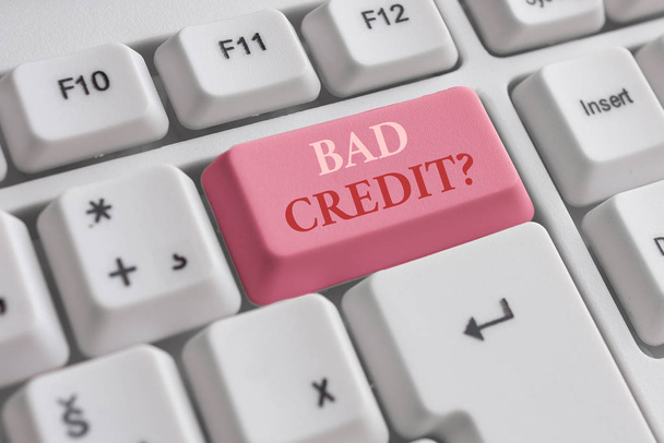 Text sign showing Bad Creditquestion. Conceptual photo inabilityof a demonstrating to repay a debt on time and in full White pc keyboard with empty note paper above white background key copy space. - Photo, Image