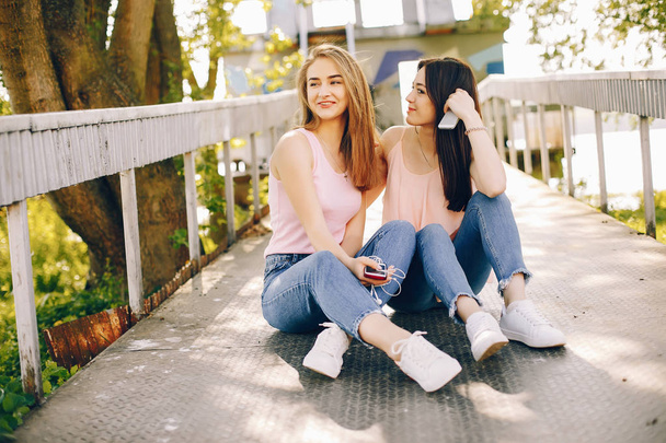 two beautiful girls in a park - Foto, afbeelding