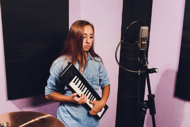 Close up of a singer recording a track in a studio. - Фото, изображение