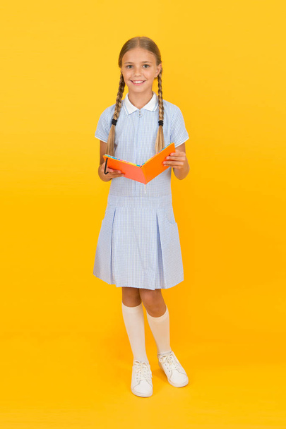 School library concept. Knowledge source. Informal education concept. Join literature club. School education. Education outside of structured curriculum. Child happy girl hold book enjoy studying - Foto, Imagen