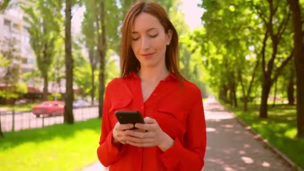 successful businesswoman using mobile in summer city - Séquence, vidéo