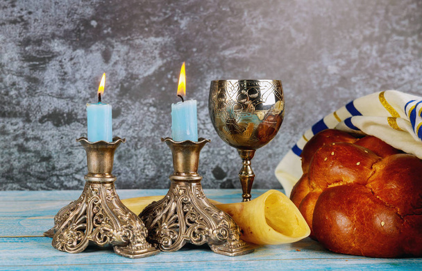 Shabbat challah bread, shabbat wine and candles on the table - Photo, Image