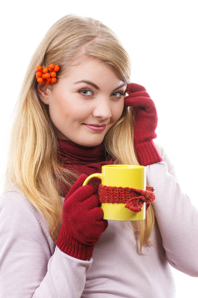 Happy smiling girl in woolen gloves holding cup of tea wrapped scarf - Foto, immagini