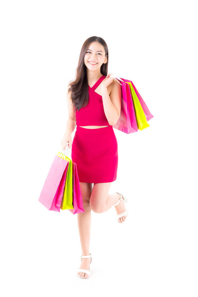 portrait of a happy excited asian woman in red dress standing an - Foto, imagen