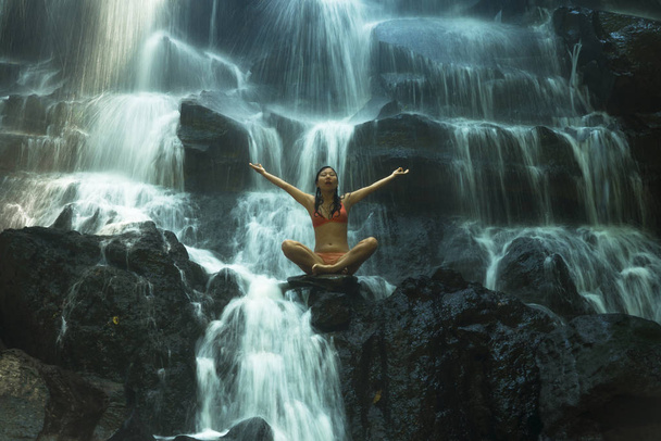 natural portrait of young beautiful and happy Asian Korean woman in bikini enjoying nature at tropical paradise waterfall with magical feeling in soul inspiration - Φωτογραφία, εικόνα