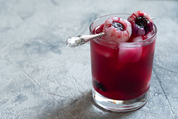 Halloween cocktail with lychee and blueberry eye - Φωτογραφία, εικόνα