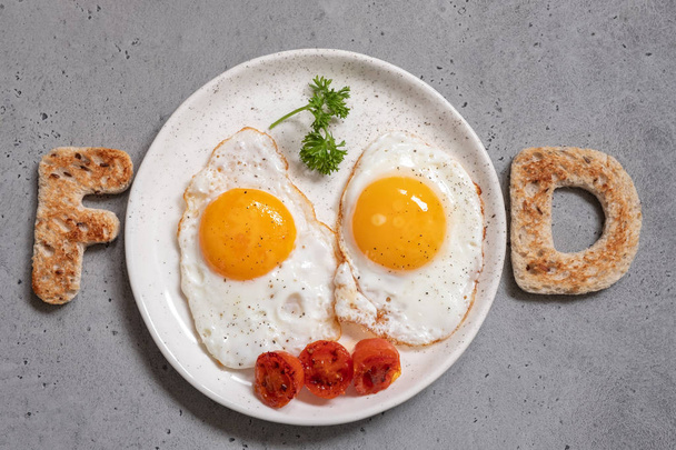 Word food written with toast letters eggs - Valokuva, kuva