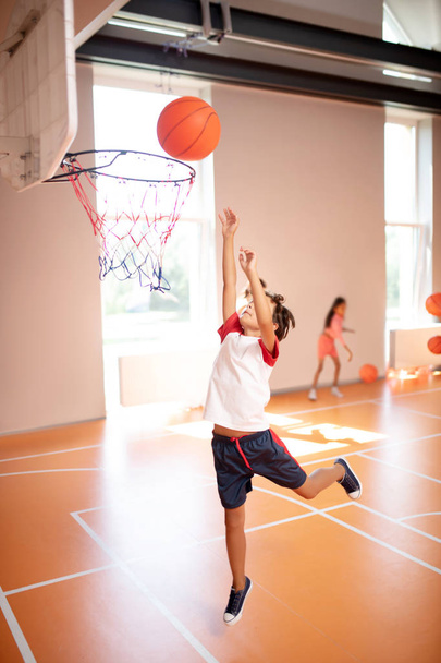 Boy jumping high while training and playing basketball - Φωτογραφία, εικόνα