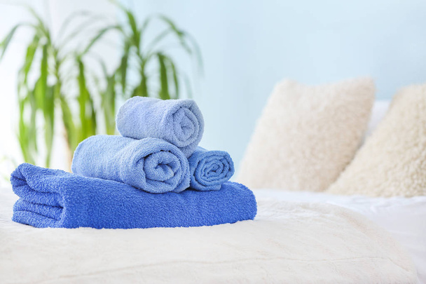 Zachte schone handdoeken op bed - Foto, afbeelding