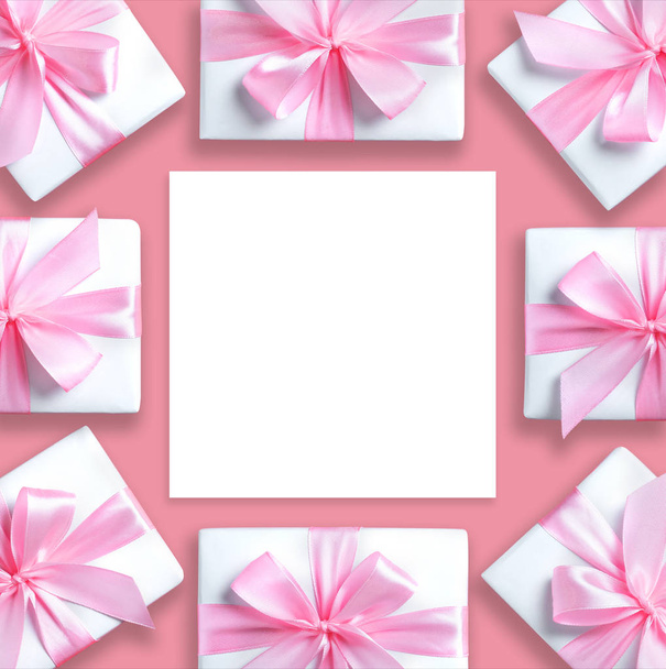 gift boxes and paper sheet on pink isolated background. - Zdjęcie, obraz