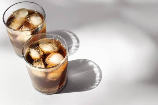 Glasses of cold cola on light background - Foto, afbeelding