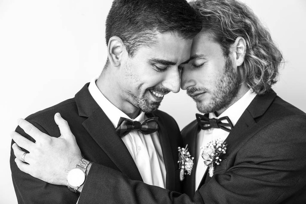 Μαύρο και άσπρο πορτρέτο του ευτυχισμένο γκέι ζευγάρι την ημέρα του γάμου τους - Φωτογραφία, εικόνα