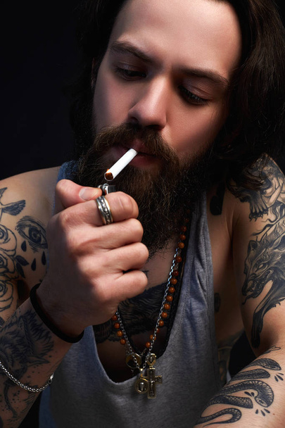 Hipster tattoed boy smoking cigarette - Photo, Image