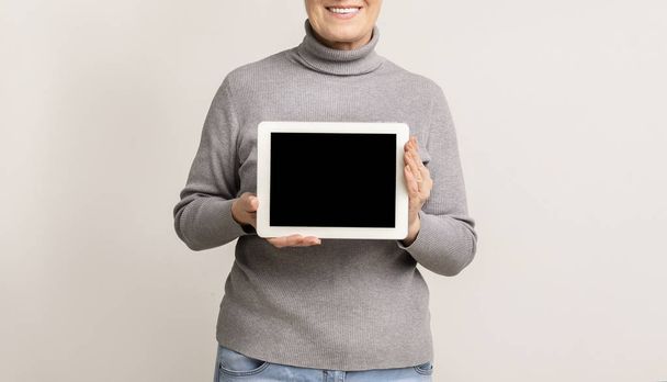 Digital tablet with blank screen in hands of elderly woman - Fotoğraf, Görsel