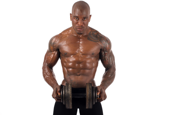 Black bodybuilder training with dumbbells. Strong man with perfect abs, shoulders,biceps, triceps and chest. Isolated on white background - Foto, Bild