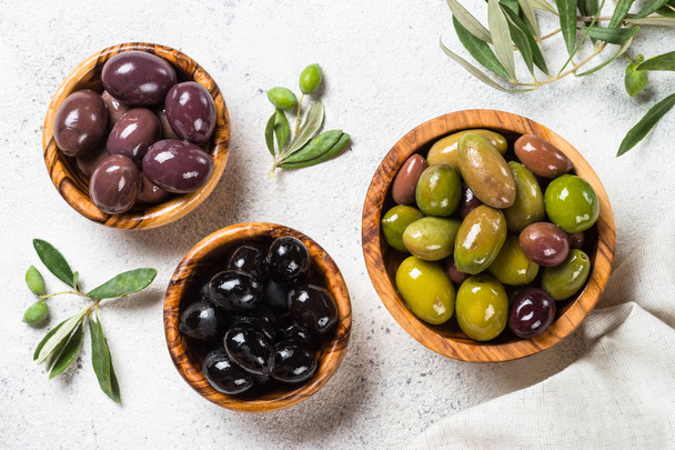 Black and green olives on white background. - Photo, Image