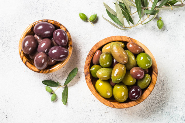Black and green olives on white background. - Photo, image