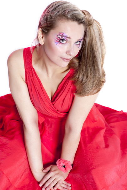 smiling woman in a red dress with original make-up - Фото, зображення