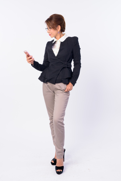Full body shot of mature Asian businesswoman using phone - Fotografie, Obrázek