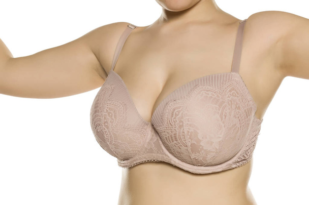 Beautiful big breasts in bra on white background - Photo, Image