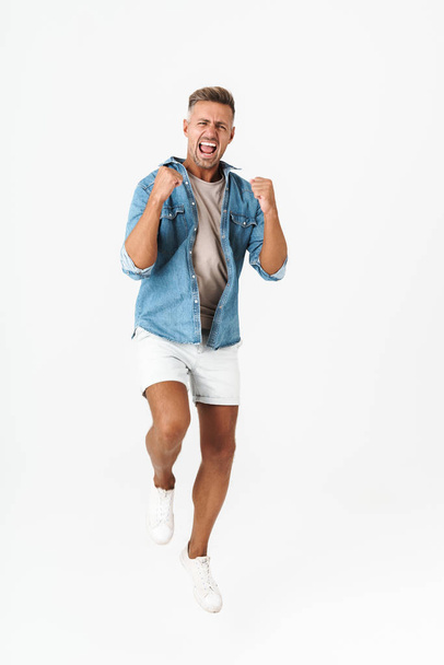 Full length photo of excited guy in denim shirt rejoicing and ge - Fotoğraf, Görsel
