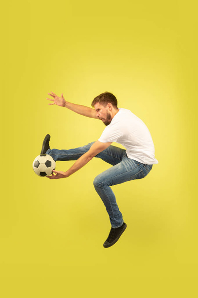 Full length portrait of happy jumping man on yellow background - Photo, Image