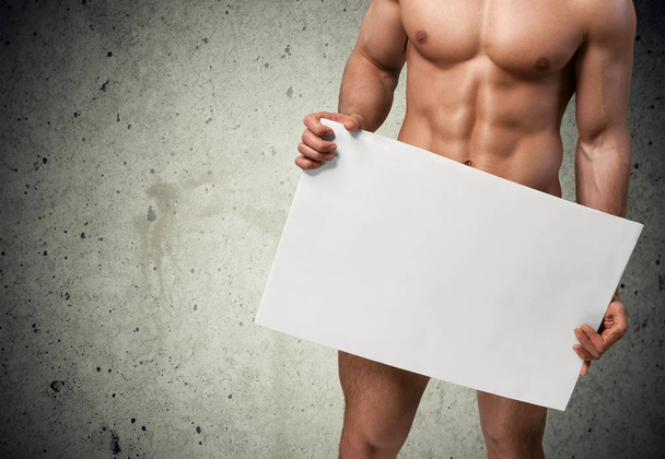 Body of Muscular Man holding blank billboard - Foto, imagen
